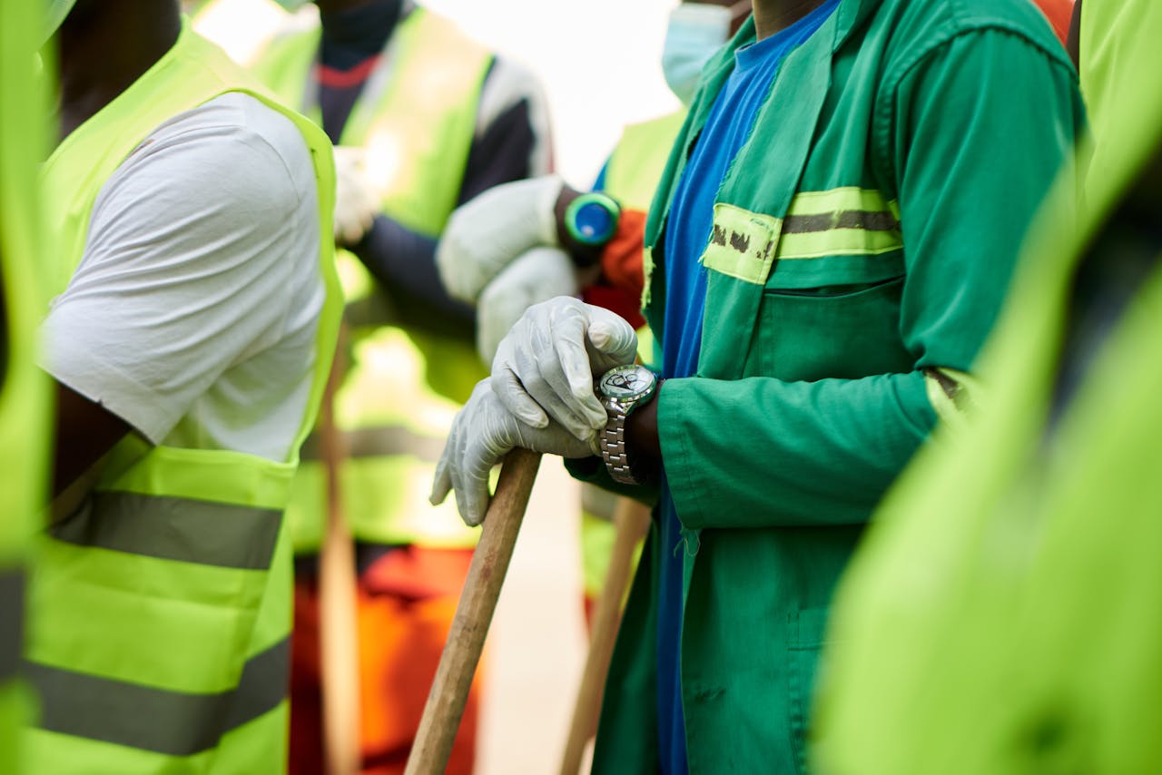 services-01 Close-up of construction workers wearing safety vests and gloves in Douala, Cameroon.