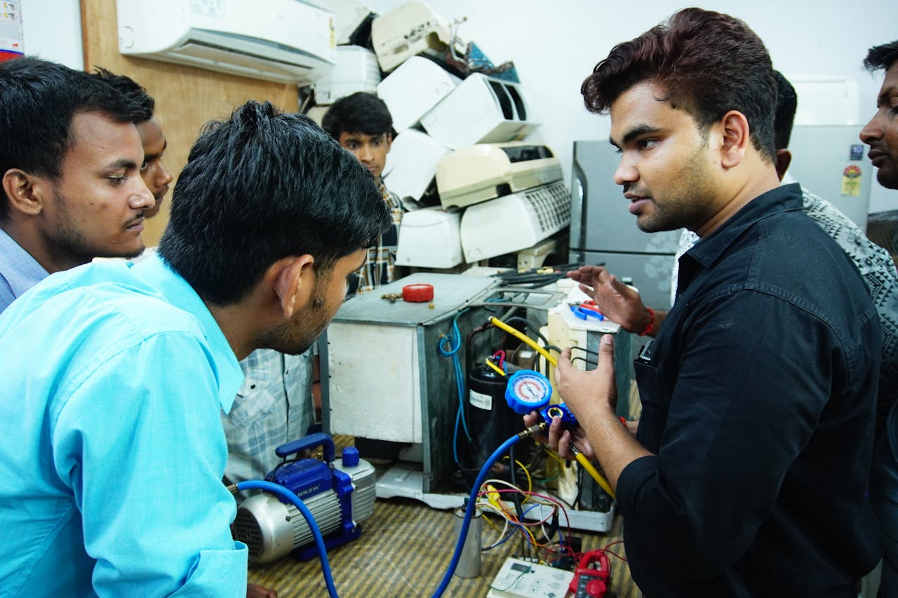 why-choose-us Participants learn AC repair during a hands-on session in Delhi, India.
